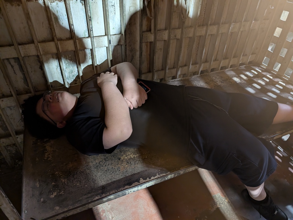 Luis laying down in jail