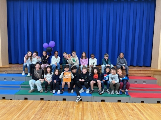 stage with blue curtains and classroom with purple balloons and trick or treat bag