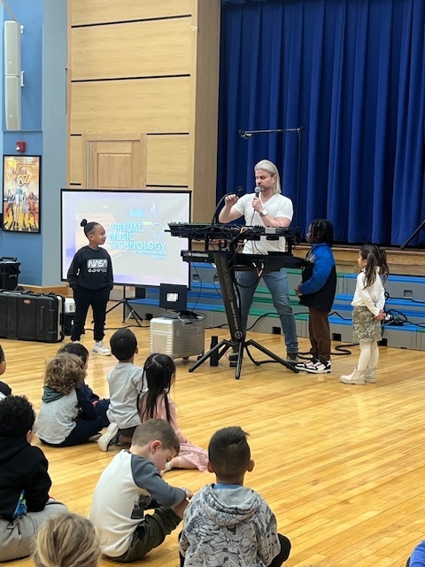 students dancing on the gym floor during assembly