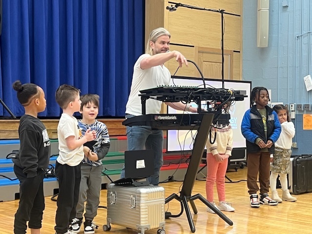 students in gym for an assembly