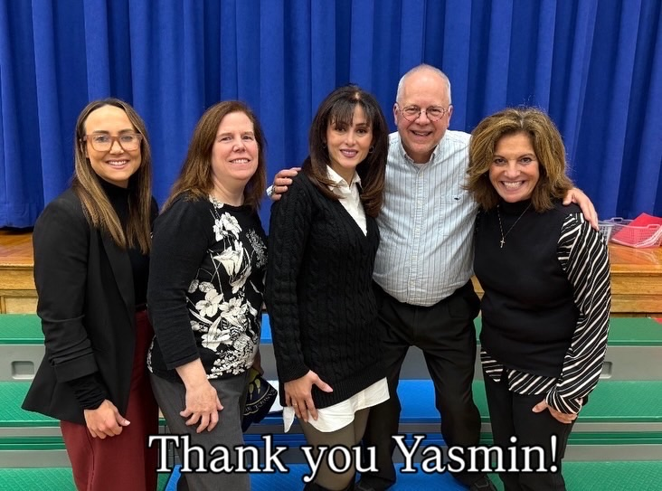 board members with blue curtain in background