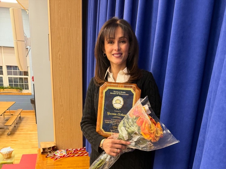 board member holding a bouquet of flowers