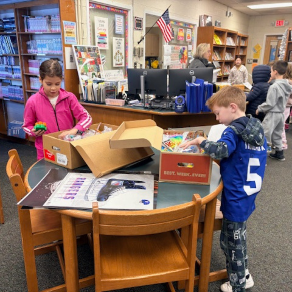 students with prize box in library