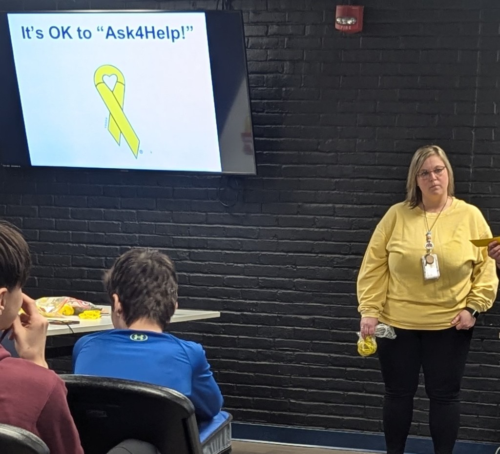 Mental Health Practitioner, Danielle Perry leading a yellow ribbon awareness presentation at Hemlock Public Schools. 