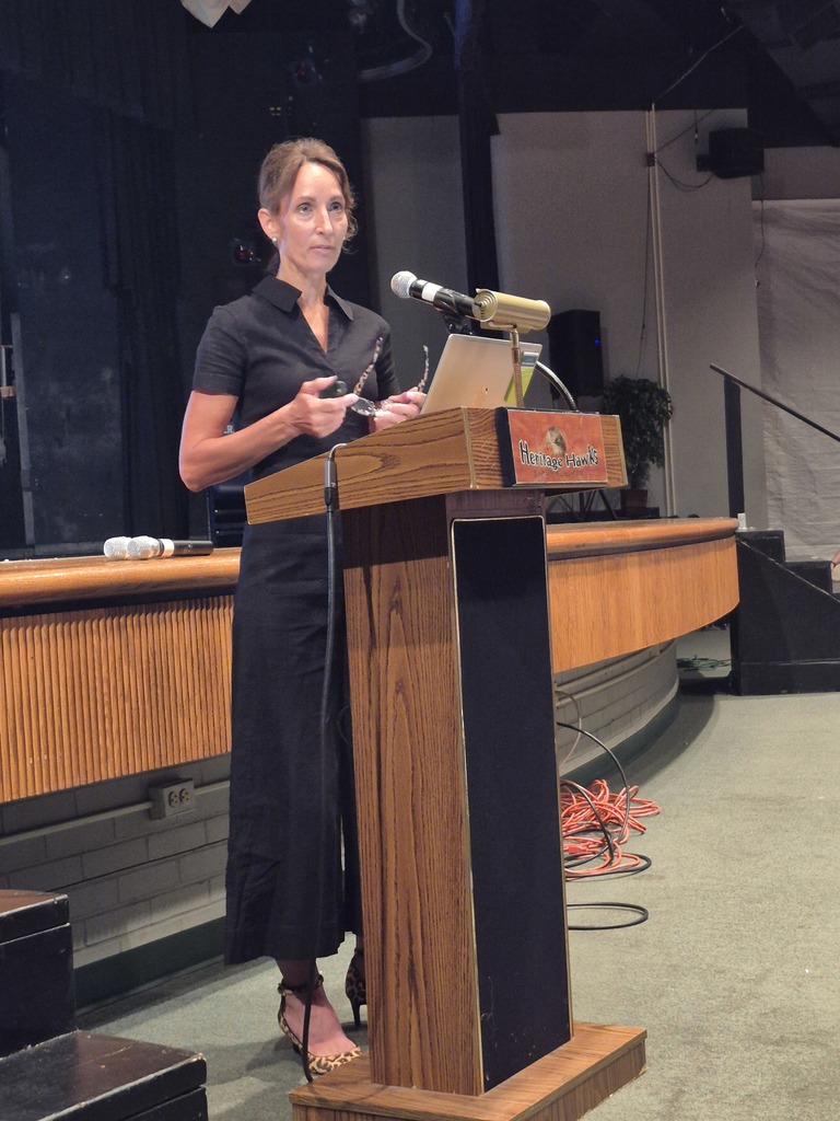 Kim Miller, ASD Teacher Consultant presents to staff behind a podium