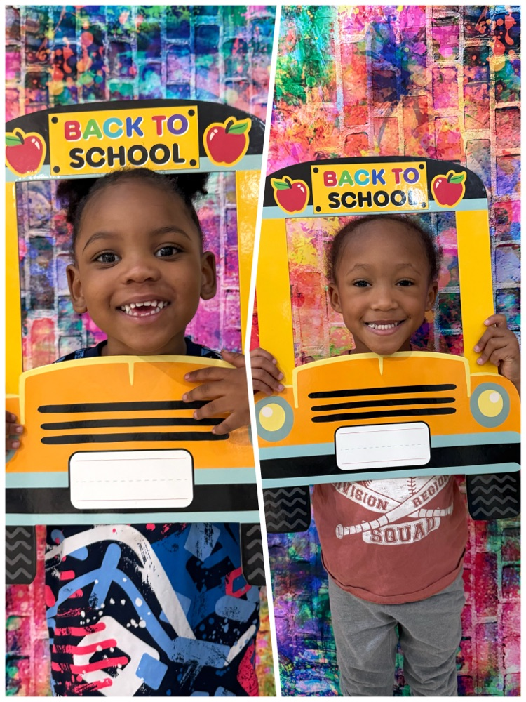 2 preschoolers with their faces in the bus sign