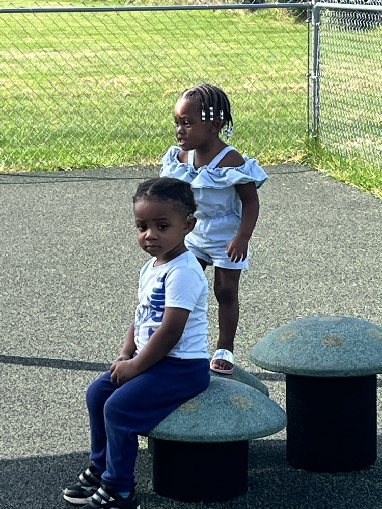 children standing and sitting outside