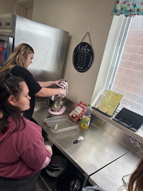 Students making brownies using a mixer