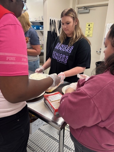 Students making breakfast burritos