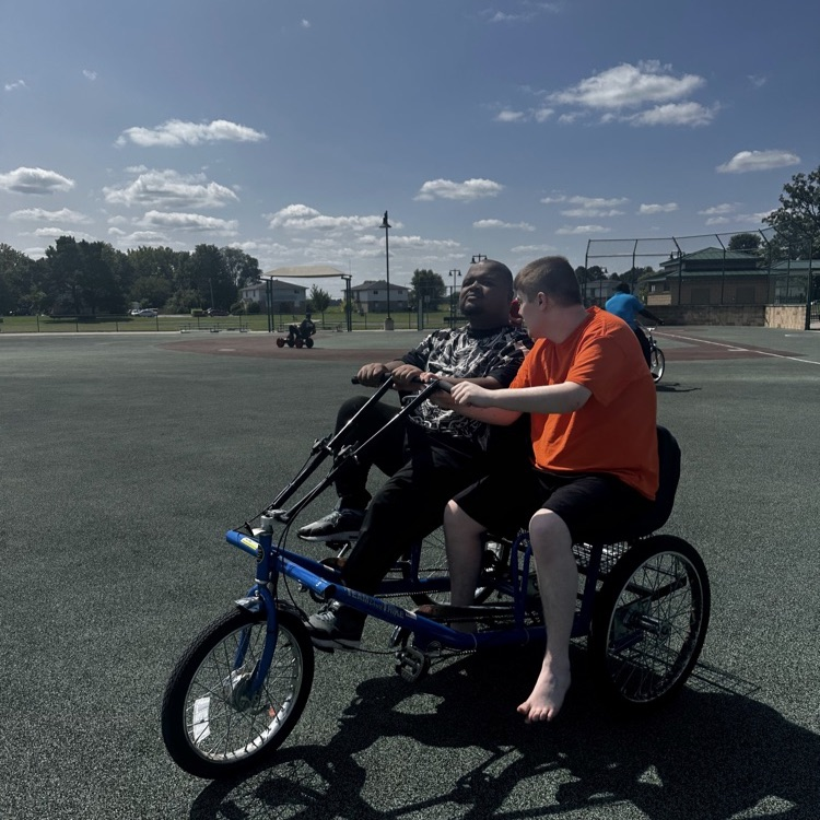 students riding a bike together.