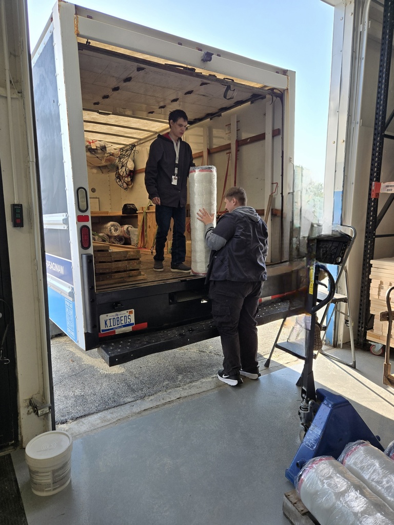 Students loading a truck with supplies
