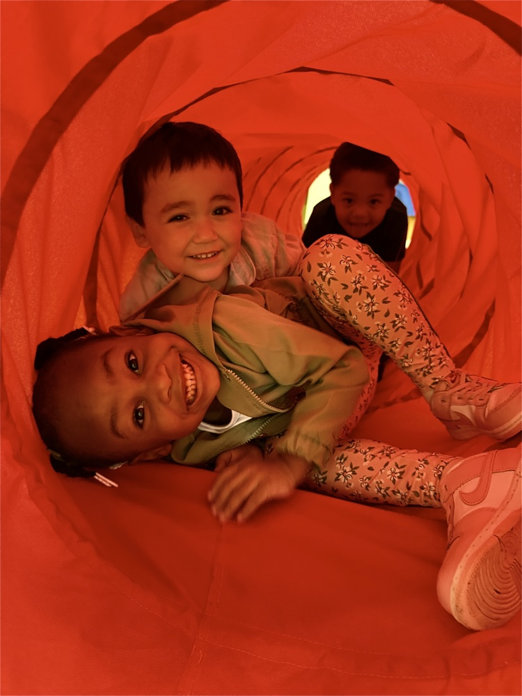 students in play tunnel.