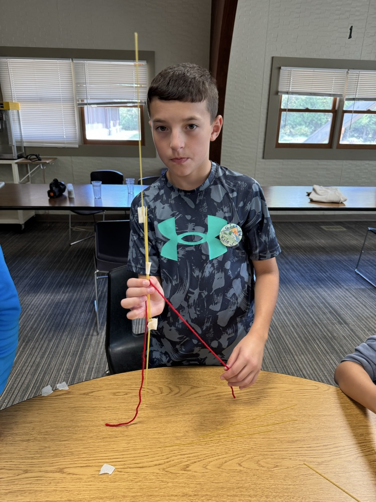 boy finishing his STEM structure