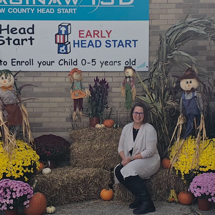 Principal Tia Hahn posing in front of Fall Harvest prop for Claytor’s  October parent club.