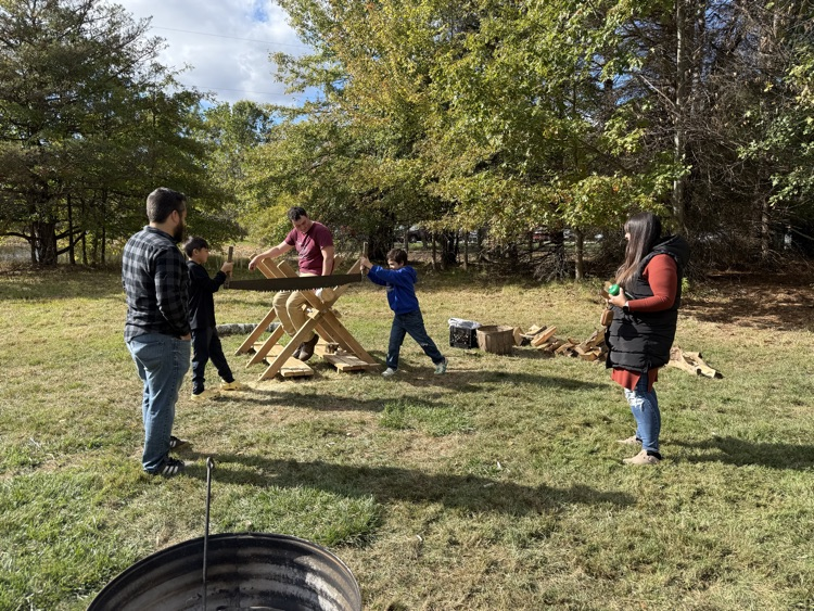 Kids cross cut sawing at Hartley Festival .