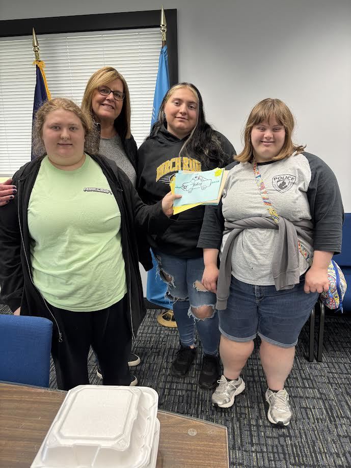 Students standing  with Thank You cards