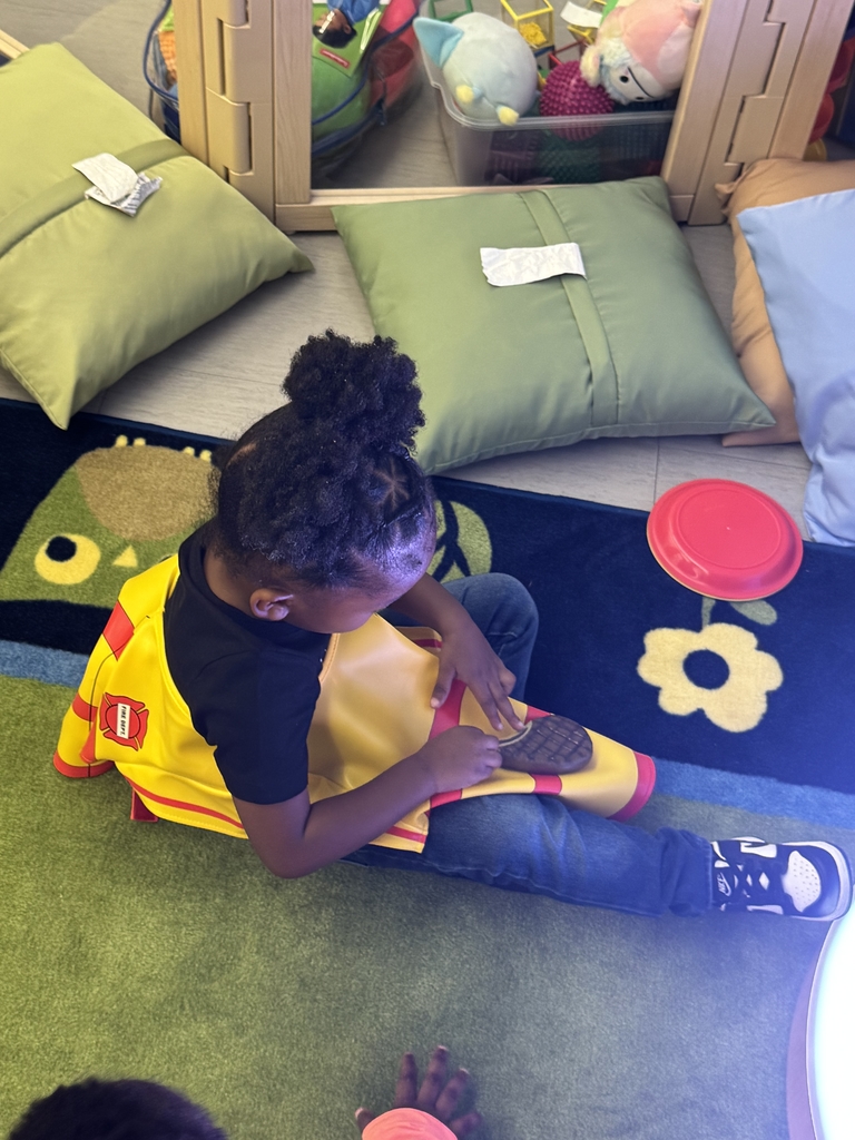 Child working near light table.
