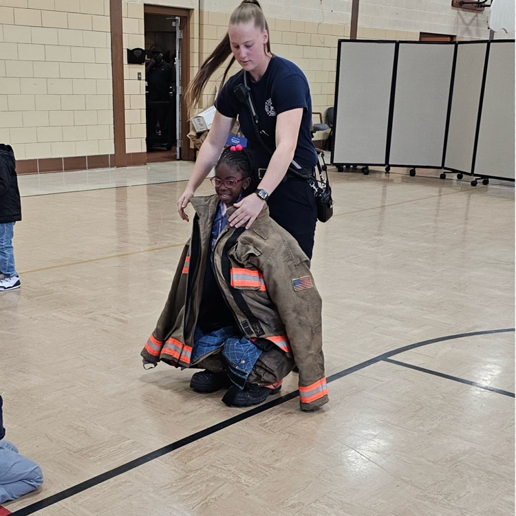 Student tries on fire fighting gear