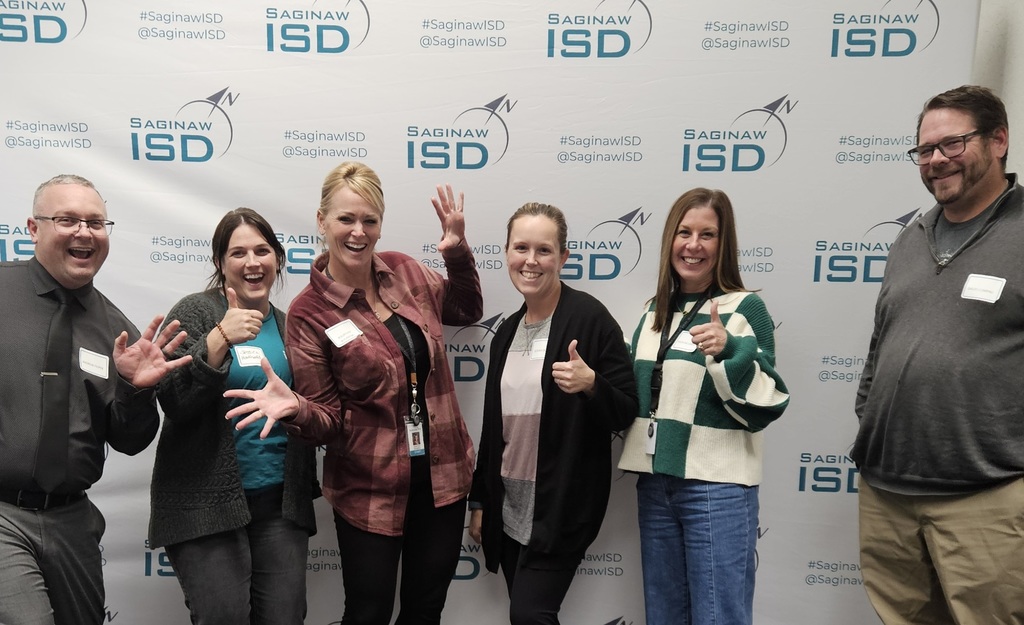 Staff members doing jazz hands smiling and having a great time!