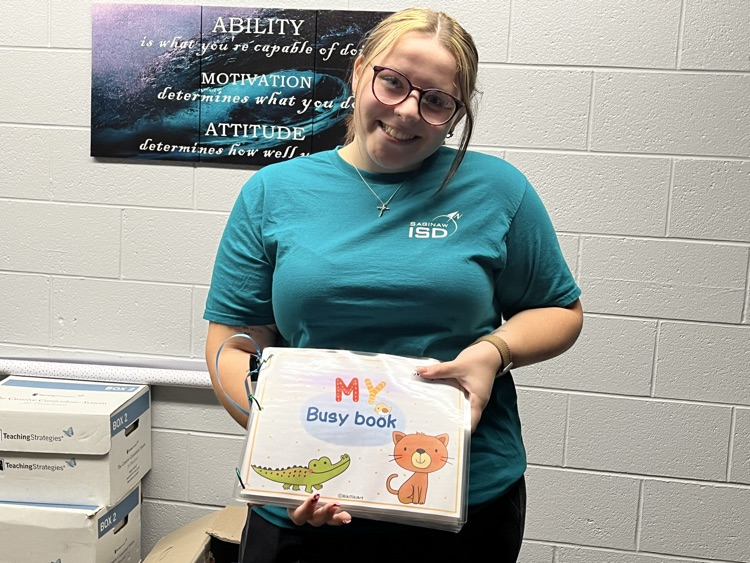 teacher holding busy book