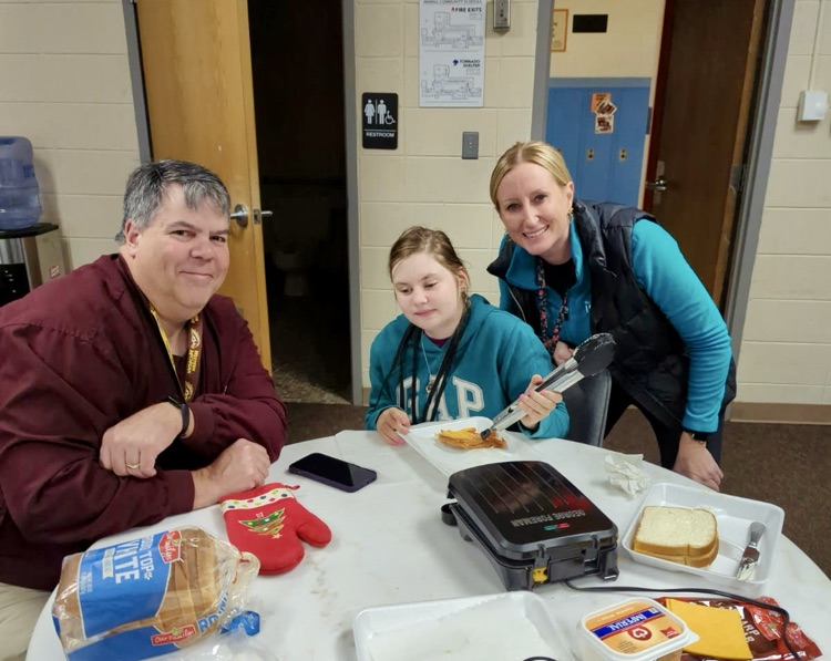 students and staff cooking grilled cheese 