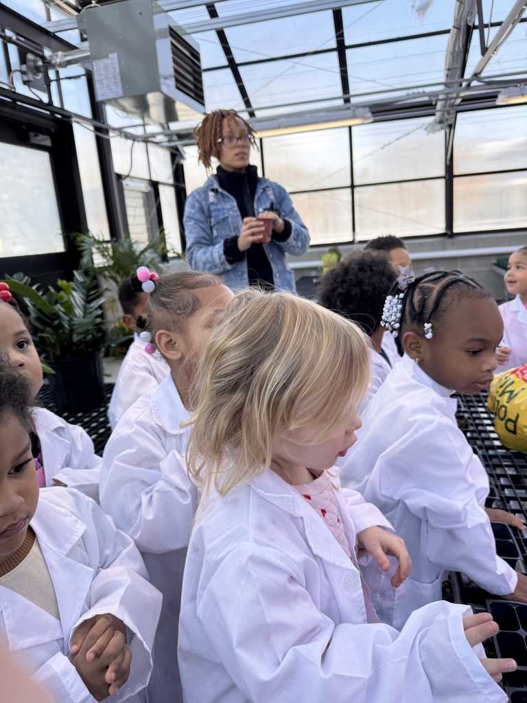 Students waiting to plant seeds in Jerome's greenhouse. 