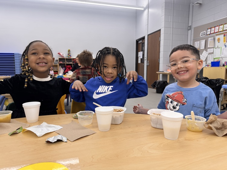 Students eating breakfast with Principal Nichols