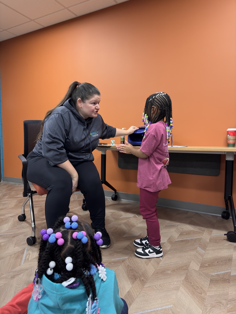Students practicing washing their hands. 