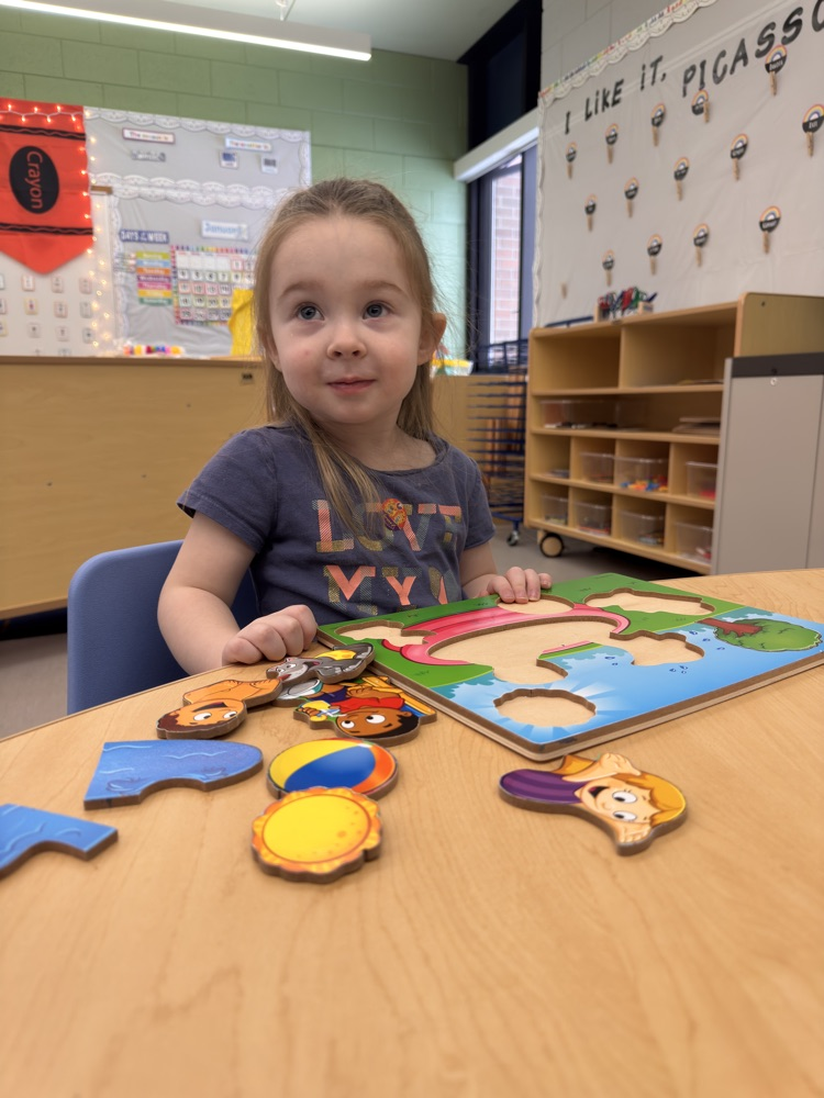 student counting puzzle pieces.
