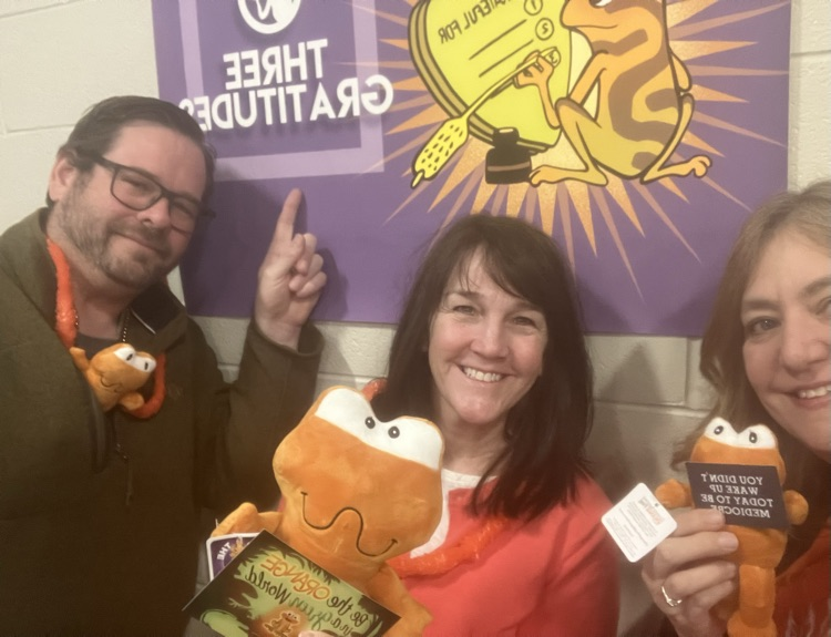 three people with orange frogs