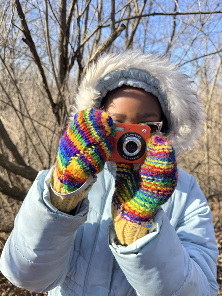 student taking a picture with camera