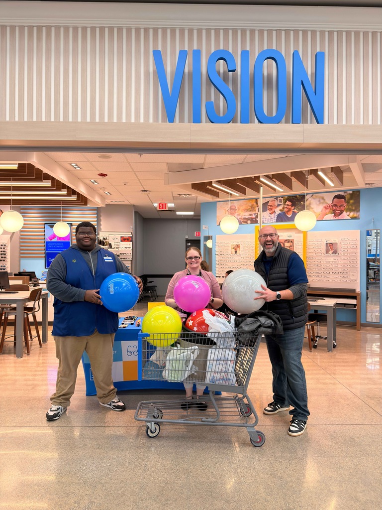 Photograph of Ted and Leon making their donation to Ms. Rabadue at War-Mart.