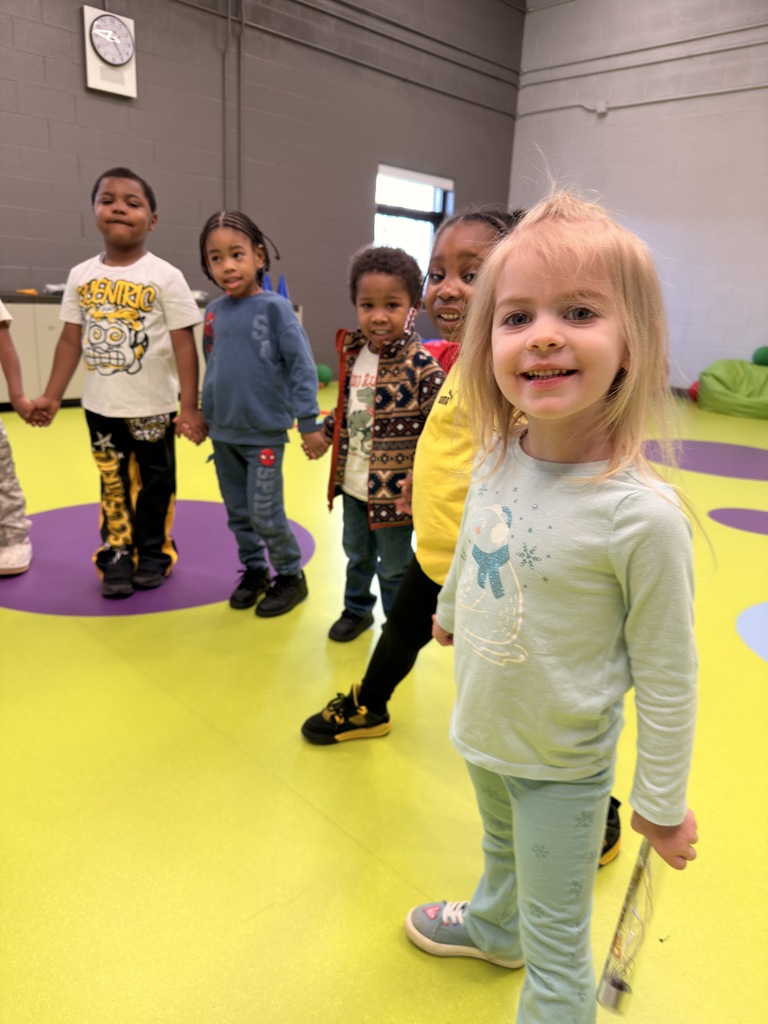 Students holding hands to show how a circuit allows the flow of energy to pass. 