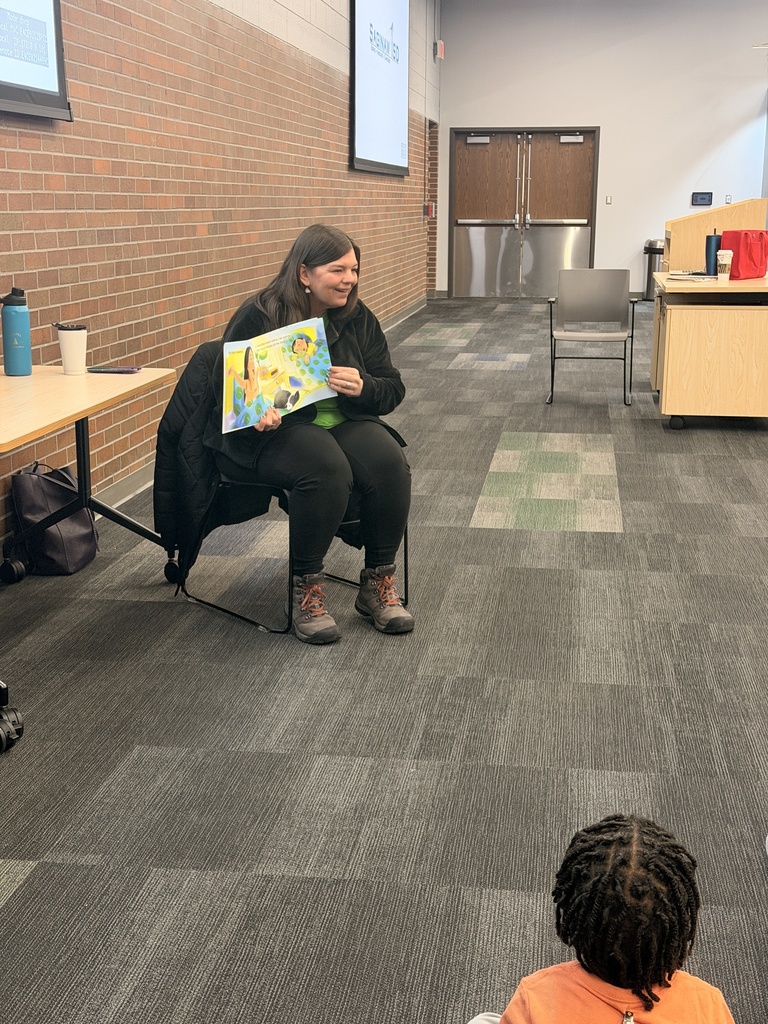 Health Department Outreach Coordinator Megan reading to students at Jerome. 