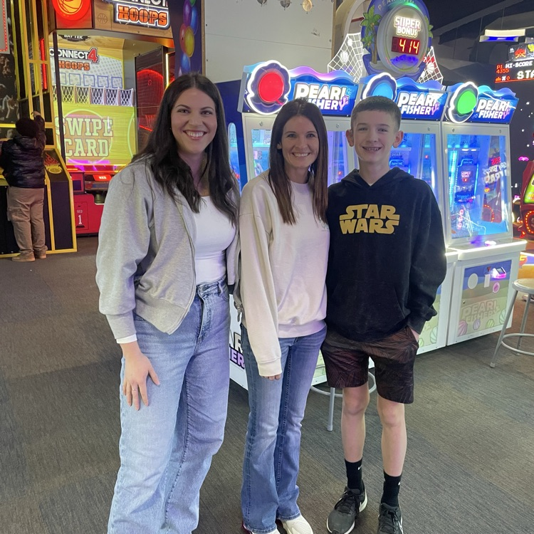 two women and one teen smiling