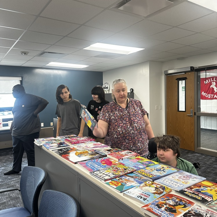 students getting a book from the book fair.