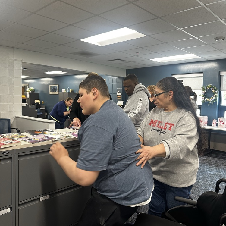 students getting a book from the book fair.