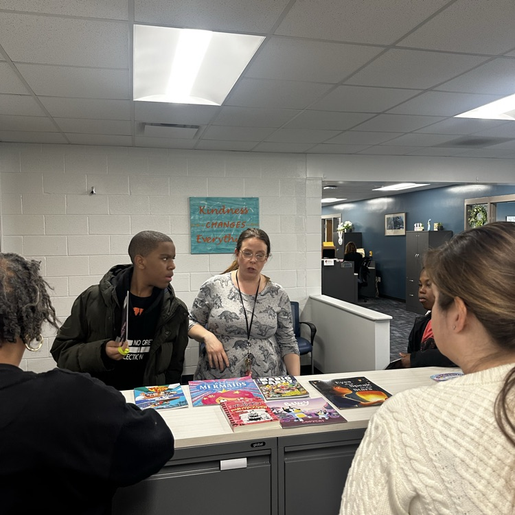 students getting a book from the book fair.