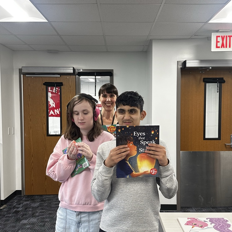students getting a book from the book fair.