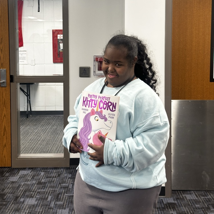students getting a book from the book fair.