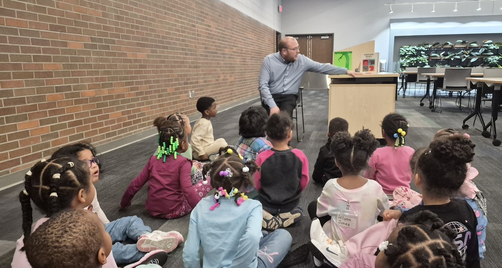 Guest reader reading to students.