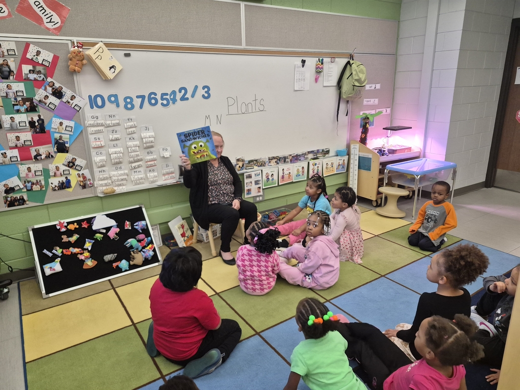Guest reader reading to students.