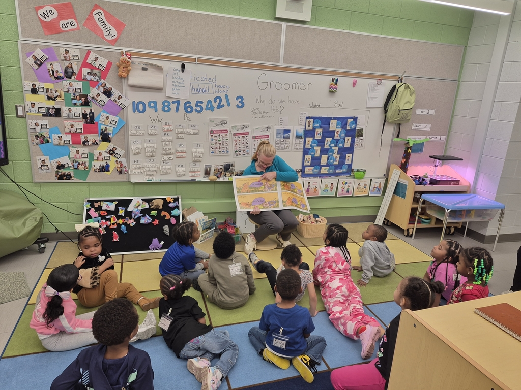 Guest reader reading to students.