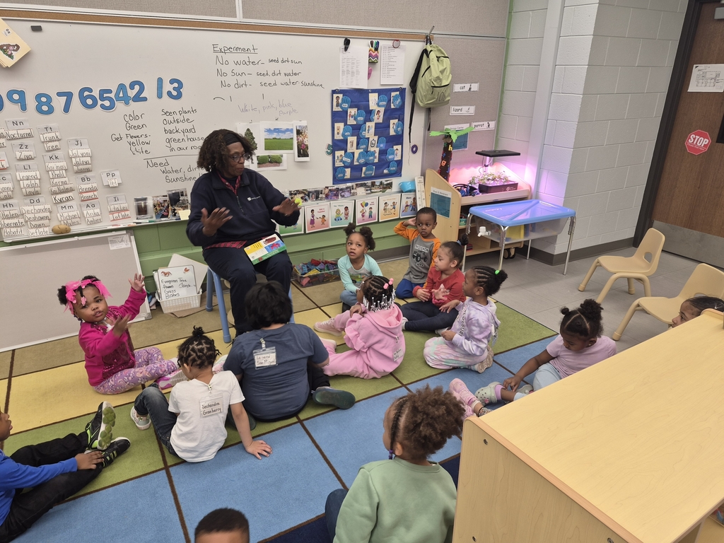 Guest reader reading to students.