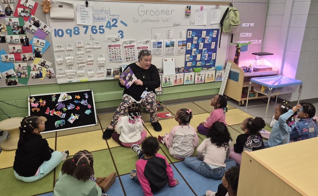 Guest reader reading to students.