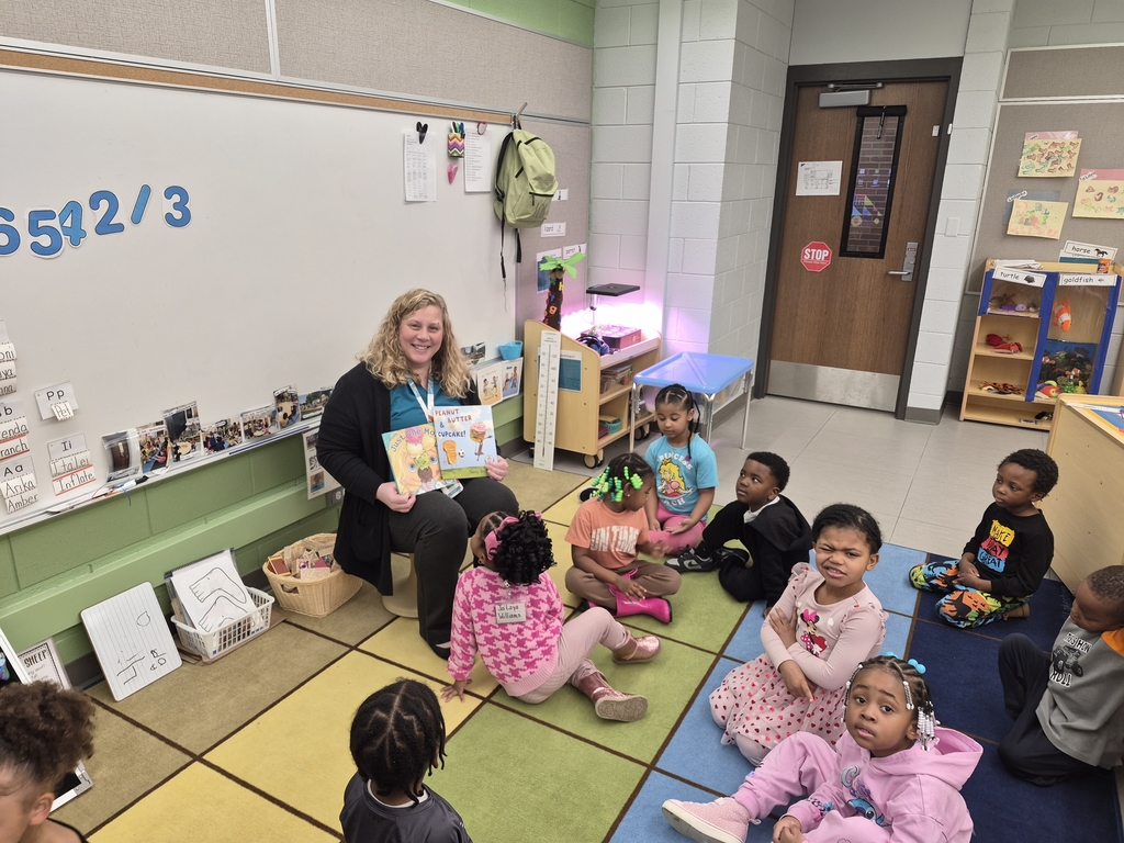 Guest reader reading to students.