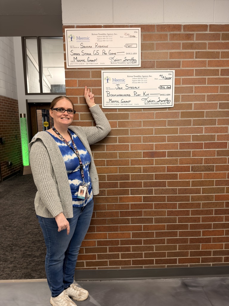 Ms. Rabadue displaying check from Meemic grant. 