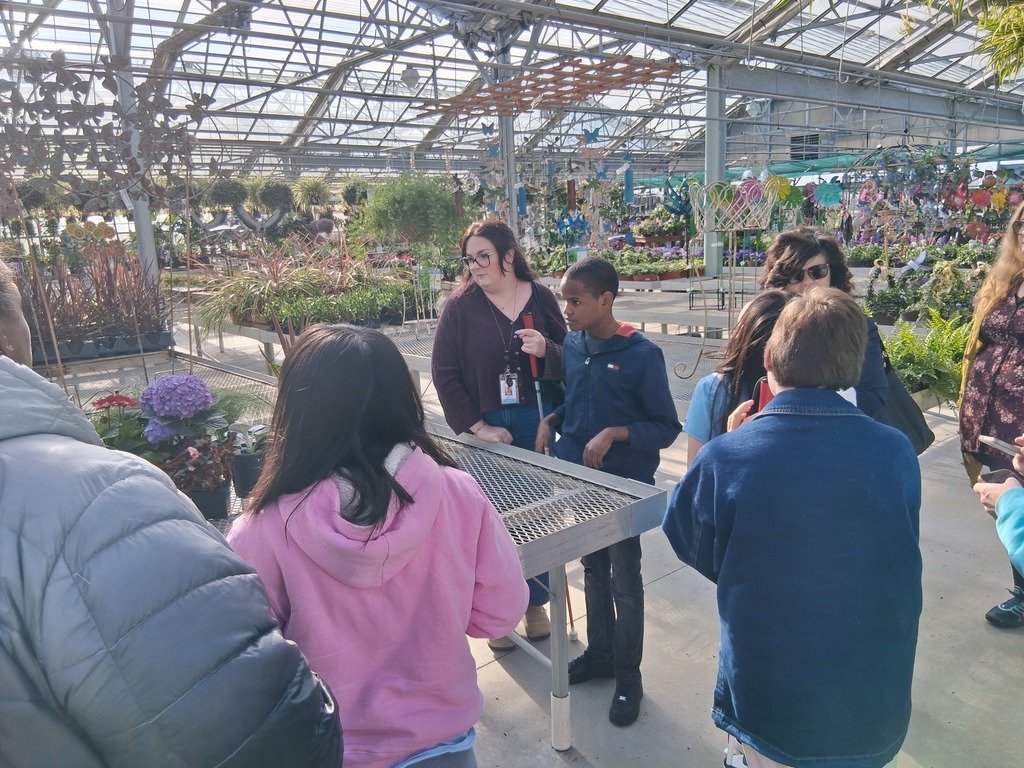 Group of students in greenhouse. 