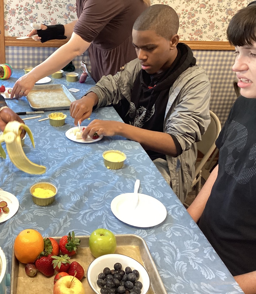 students making fruit tarts in a farmhouse kitchen