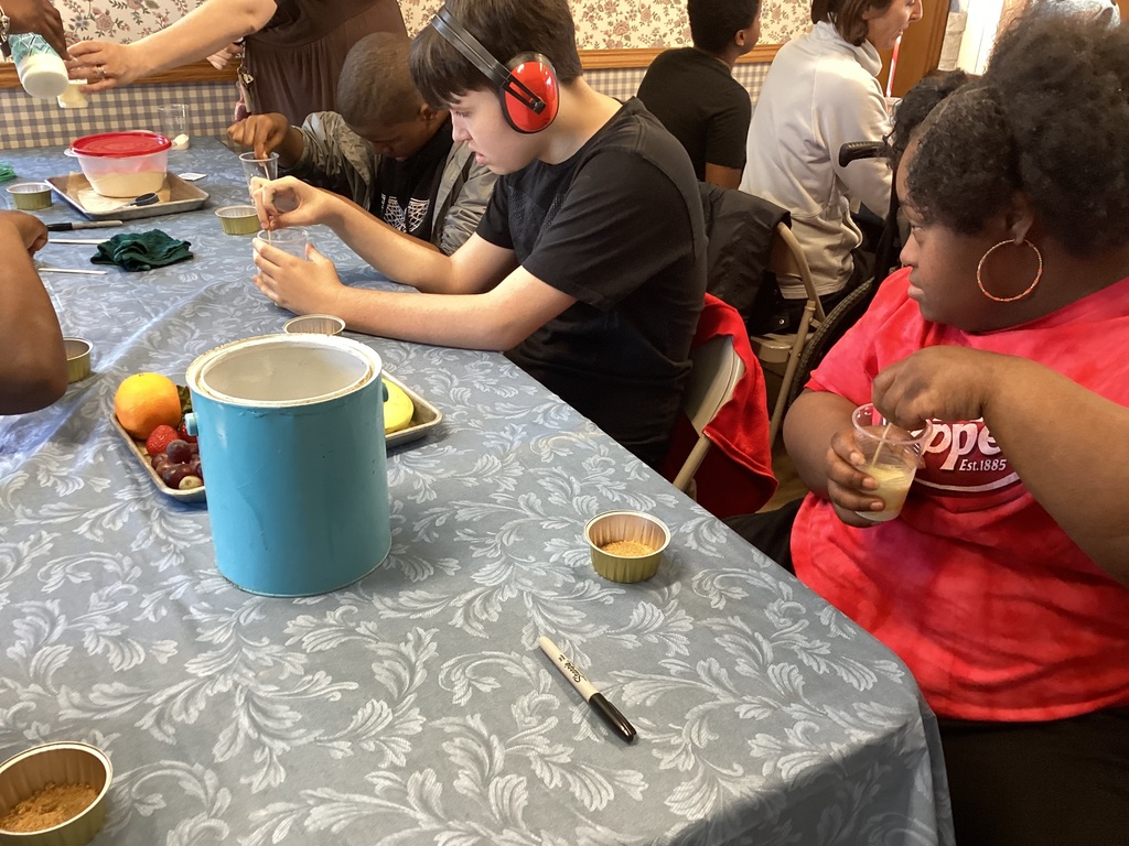 students making fruit tarts in a farmhouse kitchen